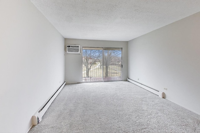 spare room featuring carpet floors, a textured ceiling, and baseboard heating