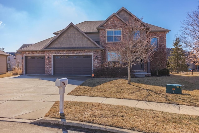 view of front of house featuring a garage, a front yard, concrete driveway, and brick siding