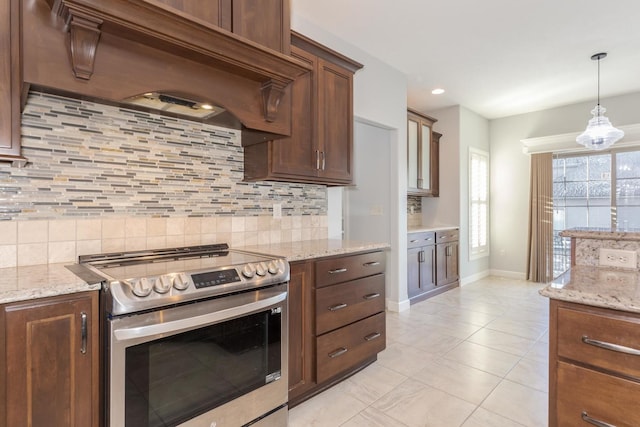 kitchen featuring decorative backsplash, custom range hood, light stone counters, decorative light fixtures, and stainless steel electric range