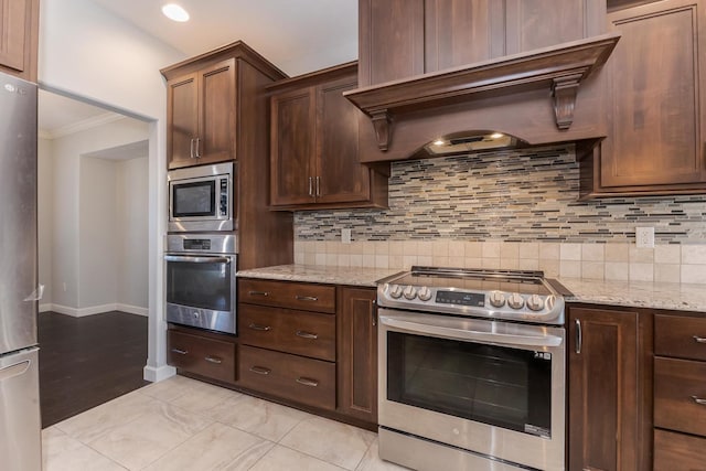 kitchen with appliances with stainless steel finishes, light stone counters, custom exhaust hood, and tasteful backsplash