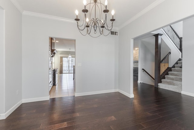 unfurnished dining area featuring baseboards, visible vents, crown molding, and wood finished floors