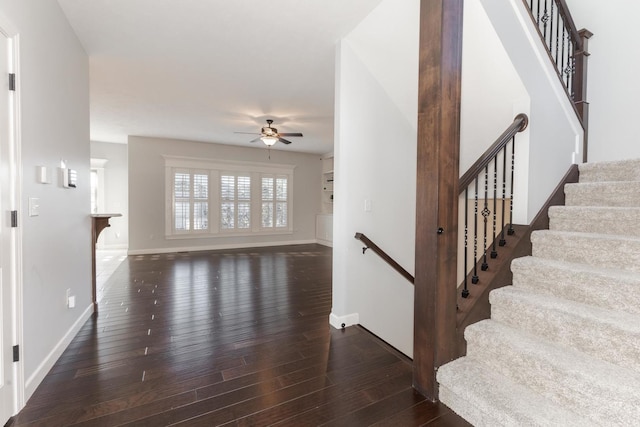 interior space with ceiling fan, baseboards, and wood finished floors