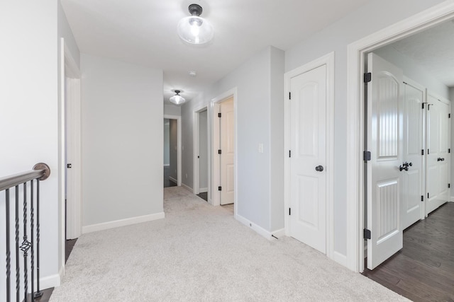 hall featuring carpet floors and baseboards