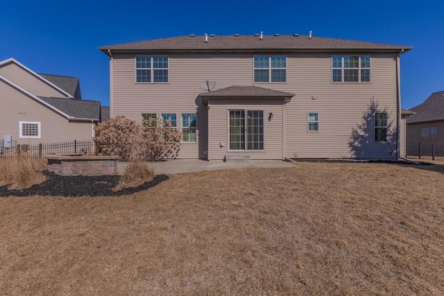 back of house featuring a patio, a yard, and fence