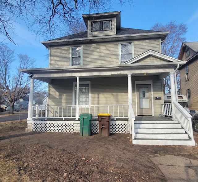 american foursquare style home with covered porch