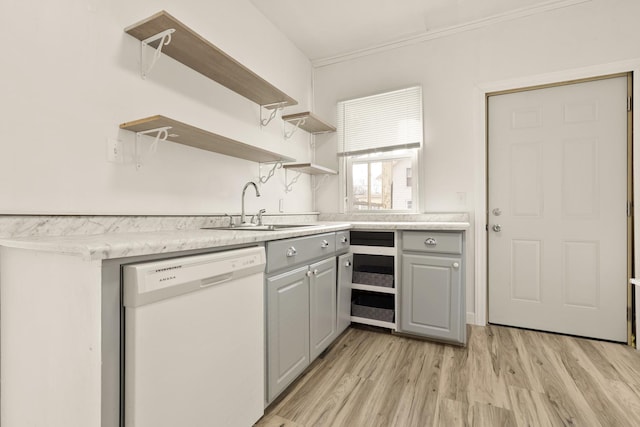 kitchen featuring white dishwasher, gray cabinets, sink, and light hardwood / wood-style flooring