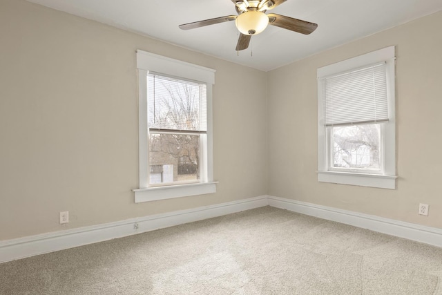 spare room with carpet floors and ceiling fan