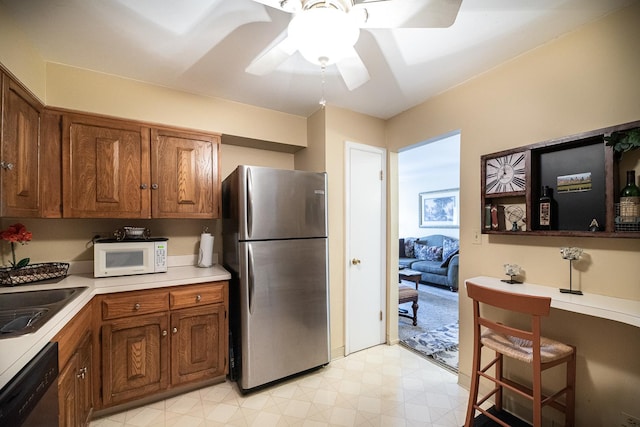 kitchen featuring ceiling fan, appliances with stainless steel finishes, and sink