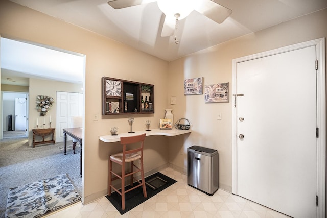 interior space with ceiling fan