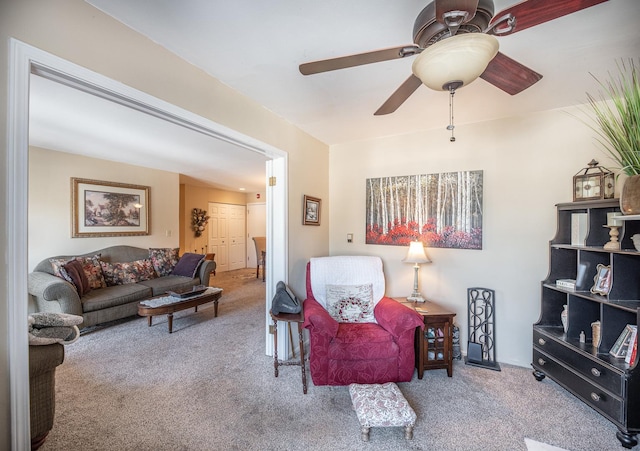 carpeted living room with ceiling fan