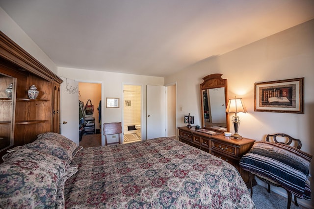 bedroom with ensuite bathroom and carpet