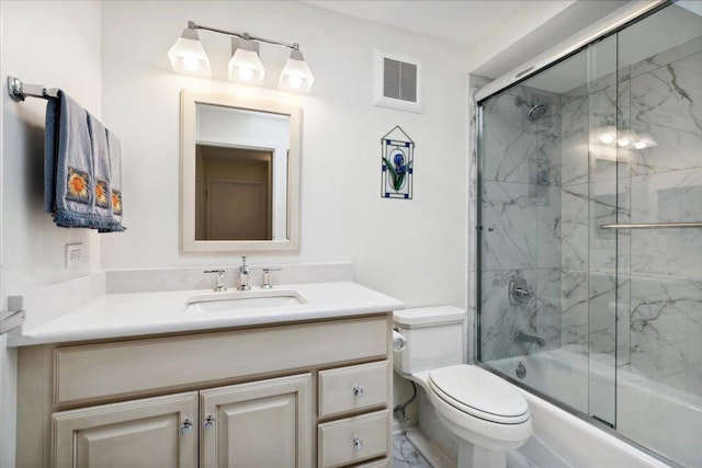 full bathroom with enclosed tub / shower combo, vanity, and toilet