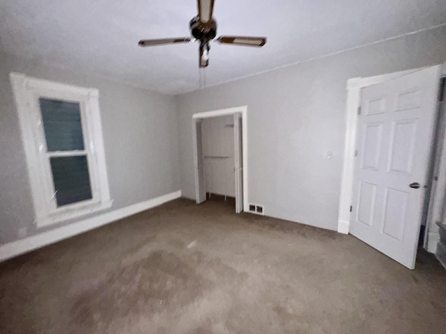 unfurnished bedroom featuring ceiling fan and carpet floors