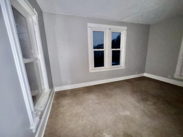 911 S Peoria Ave, Dixon, IL 61021 - spare room with baseboards and dark carpet