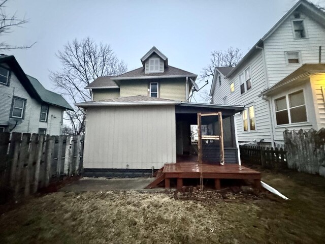 911 S Peoria Ave, Dixon, IL 61021 - rear view of house with fence and a wooden deck