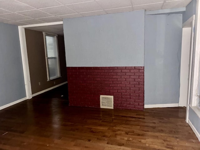 911 S Peoria Ave, Dixon, IL 61021 - unfurnished room featuring baseboards, visible vents, a drop ceiling, and wood finished floors