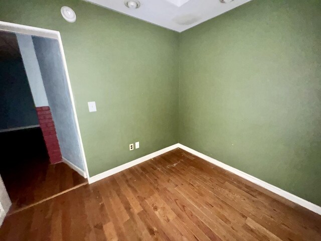 basement with dark wood-type flooring and a paneled ceiling