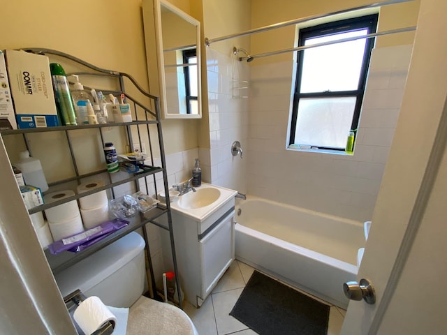 full bathroom featuring tiled shower / bath combo, vanity, tile patterned flooring, and toilet