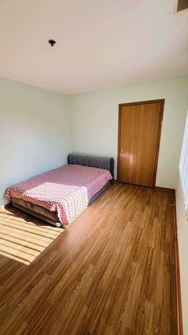 bedroom with a closet and light hardwood / wood-style flooring