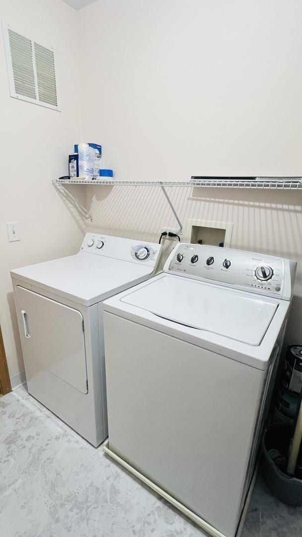 washroom with washing machine and dryer