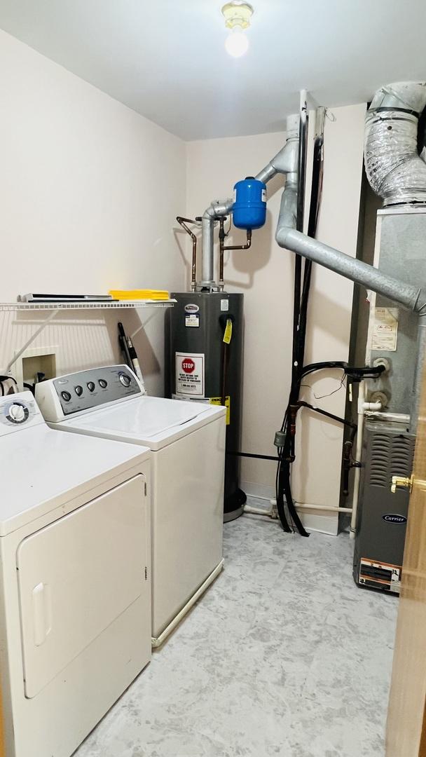 clothes washing area with independent washer and dryer and electric water heater