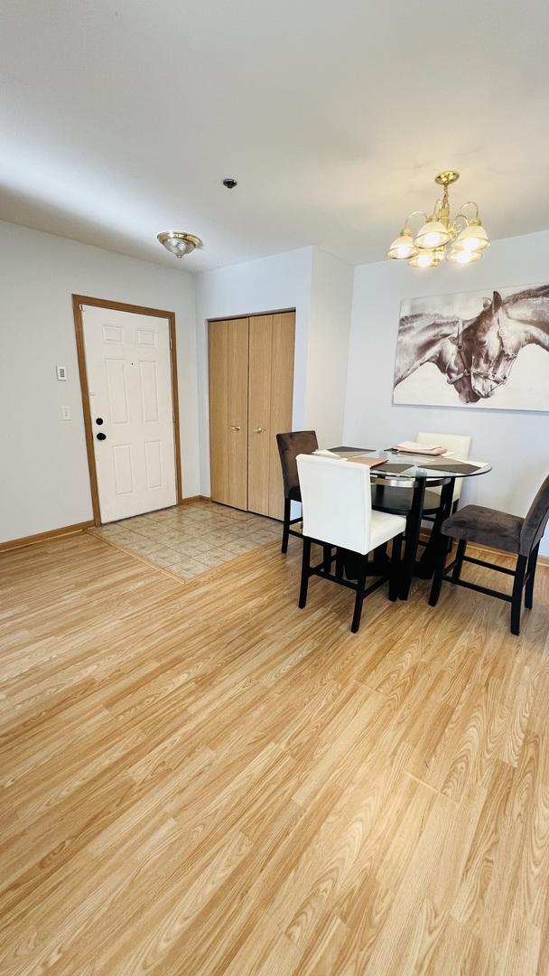 dining room featuring an inviting chandelier and light wood-type flooring