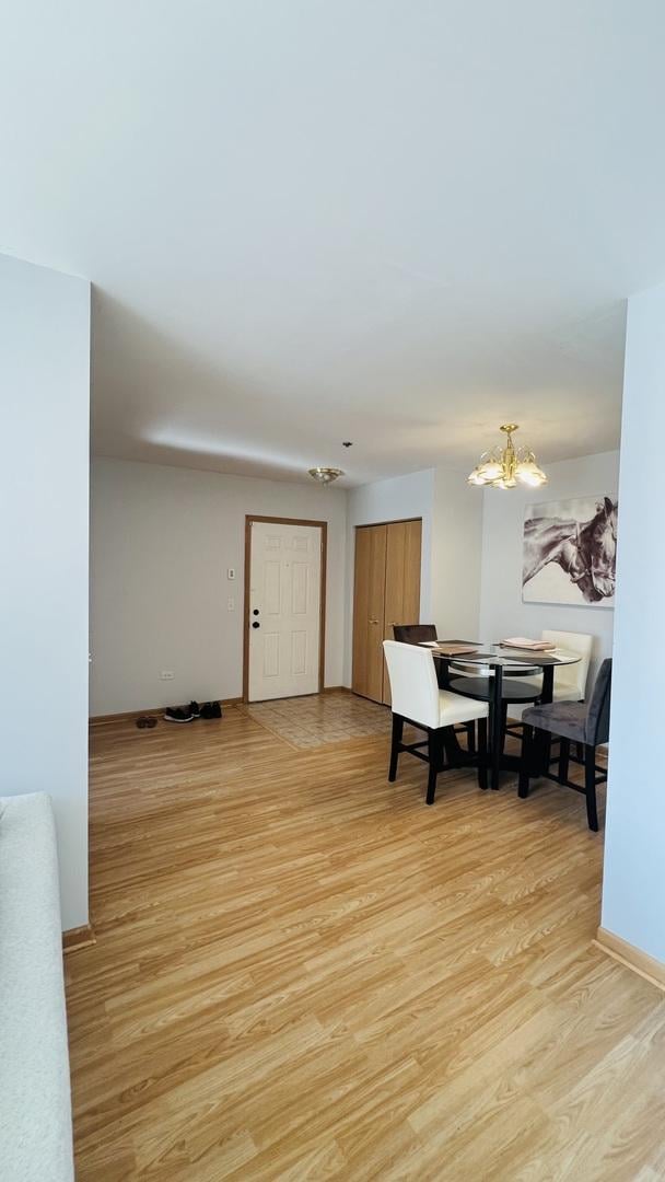 dining space with an inviting chandelier and light hardwood / wood-style floors