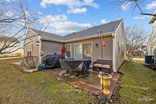 rear view of house with central AC, a patio, and a lawn