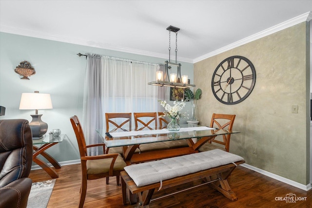 dining space featuring crown molding, wood-type flooring, and a chandelier