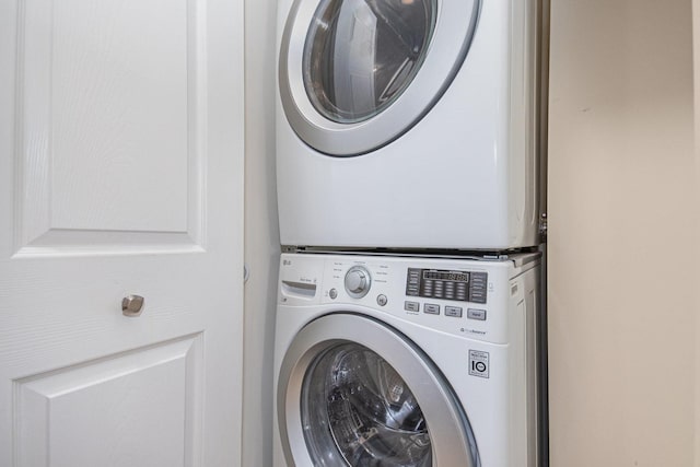 laundry area featuring stacked washer / dryer