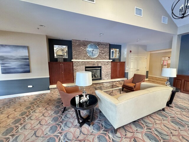 carpeted living room featuring a brick fireplace and high vaulted ceiling