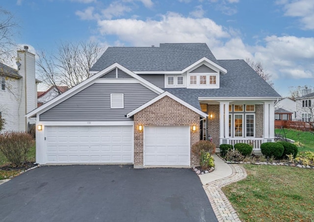 view of front of home featuring a porch, brick siding, aphalt driveway, and roof with shingles