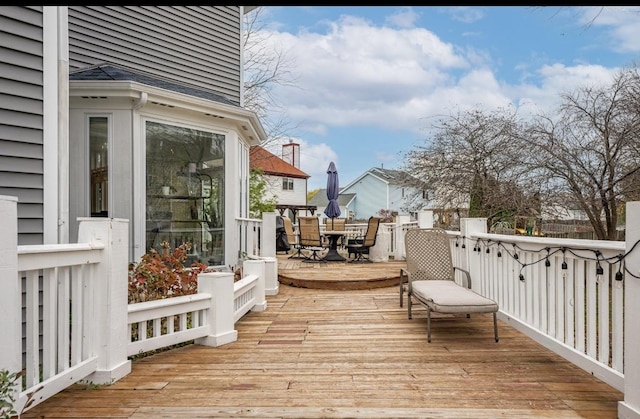 wooden terrace with outdoor dining space