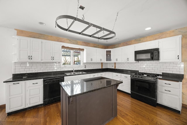 kitchen featuring sink, dark hardwood / wood-style floors, black appliances, white cabinets, and a kitchen island