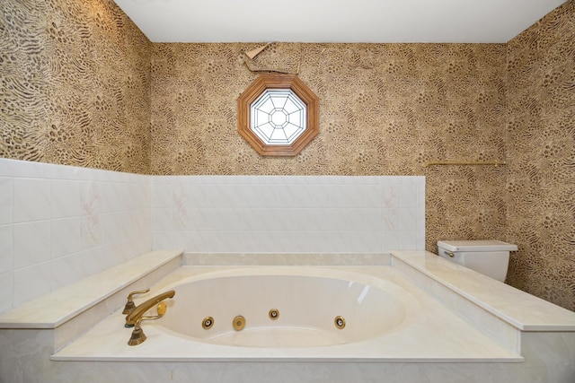 bathroom featuring a washtub and toilet