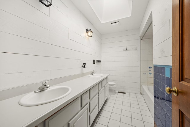 bathroom featuring wood walls, tile walls, tile patterned flooring, vanity, and toilet