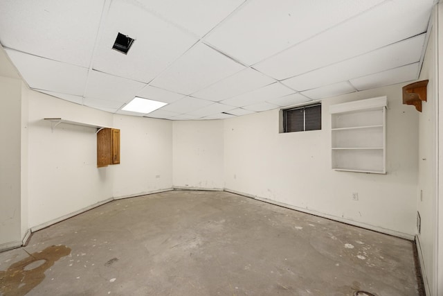 basement with a paneled ceiling