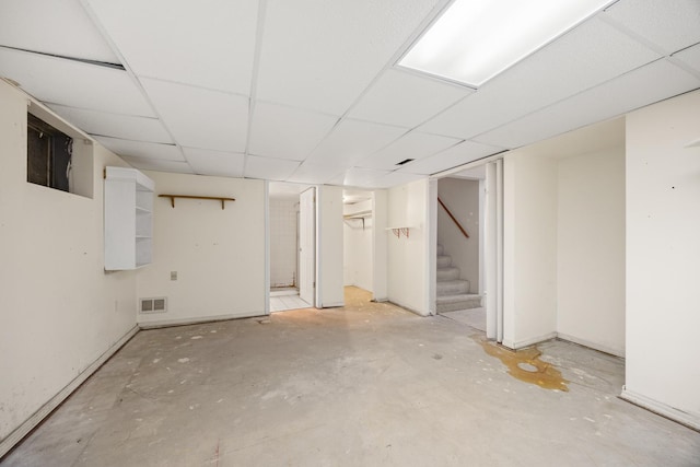 basement with a paneled ceiling