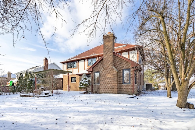 snow covered property with cooling unit