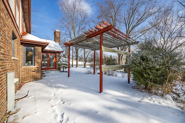 yard covered in snow with a pergola