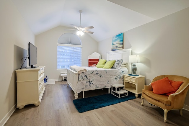 bedroom featuring lofted ceiling, light hardwood / wood-style floors, and ceiling fan