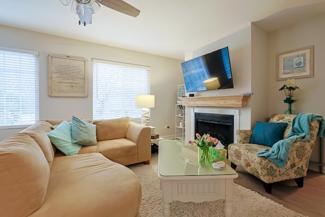 living room featuring light hardwood / wood-style flooring, a wealth of natural light, and ceiling fan