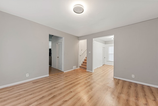 empty room with light hardwood / wood-style flooring