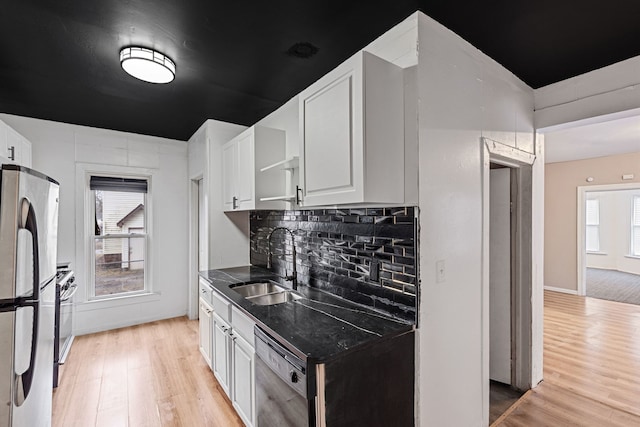 480 E Birch St, Kankakee, IL 60901 - kitchen with stainless steel appliances, light wood-type flooring, decorative backsplash, white cabinetry, and dark stone countertops