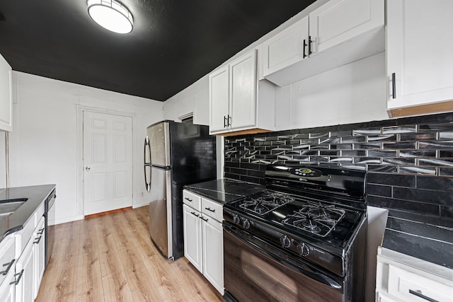 480 E Birch St, Kankakee, IL 60901 - kitchen featuring stainless steel appliances, light wood-style floors, white cabinetry, dark countertops, and backsplash