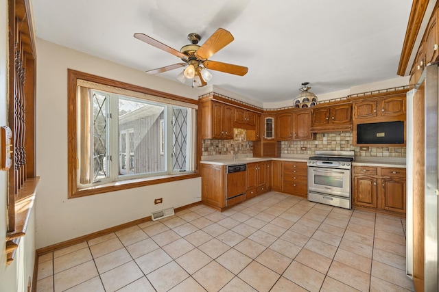 kitchen featuring stainless steel range, dishwasher, decorative backsplash, and light tile patterned floors