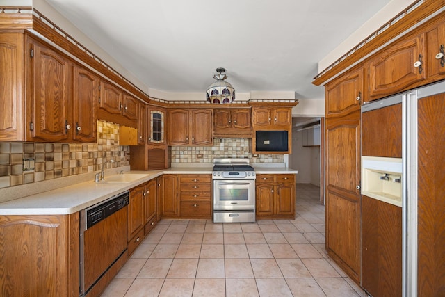 kitchen featuring sink, dishwashing machine, decorative backsplash, paneled built in fridge, and stainless steel gas range