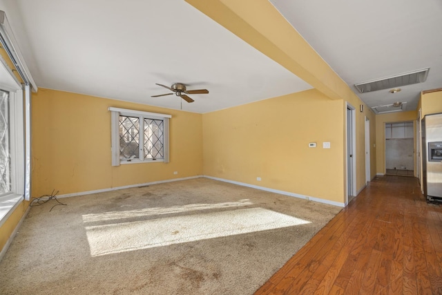 spare room featuring hardwood / wood-style floors and ceiling fan