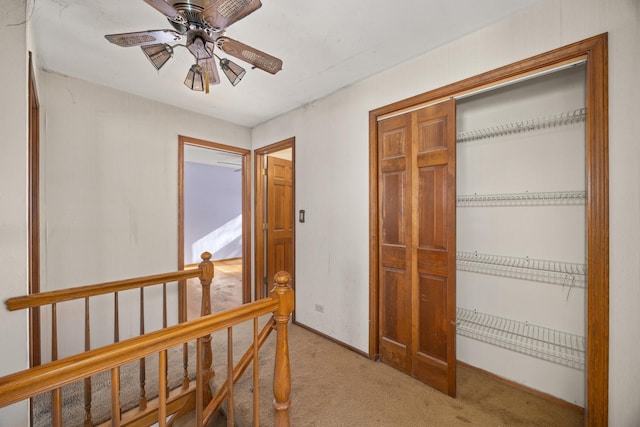 corridor featuring light colored carpet