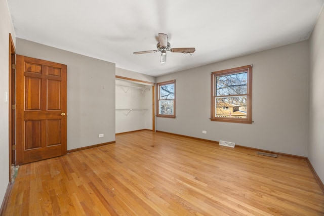 unfurnished bedroom with a closet, ceiling fan, and light hardwood / wood-style flooring